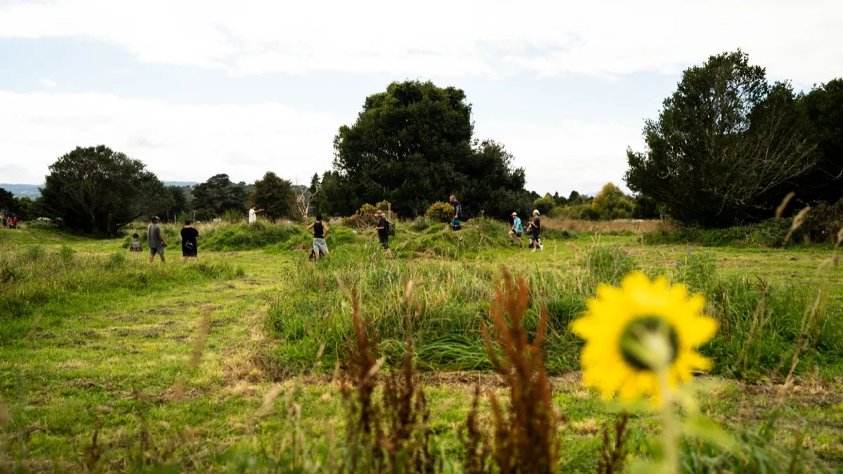 Players making their way through the wildflower meadow