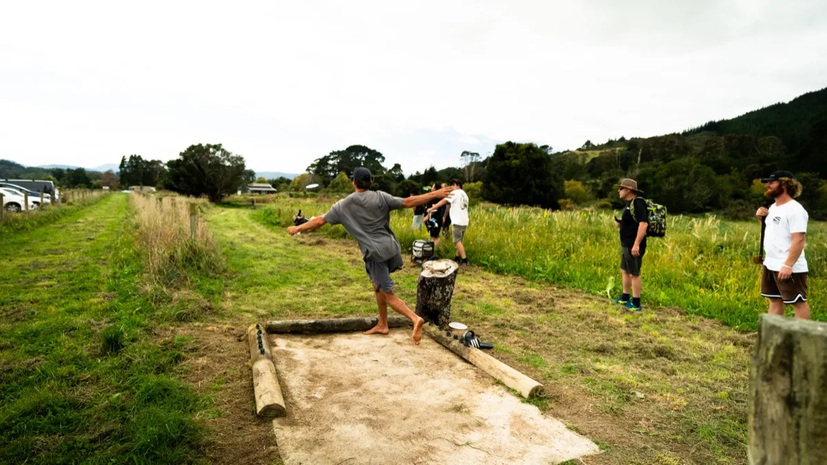 A barefoot drive off the tee pad, fairway stretching ahead