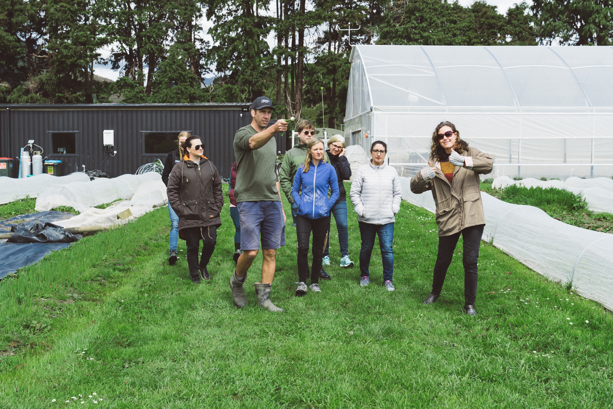 The cohort walking past the greenhouse