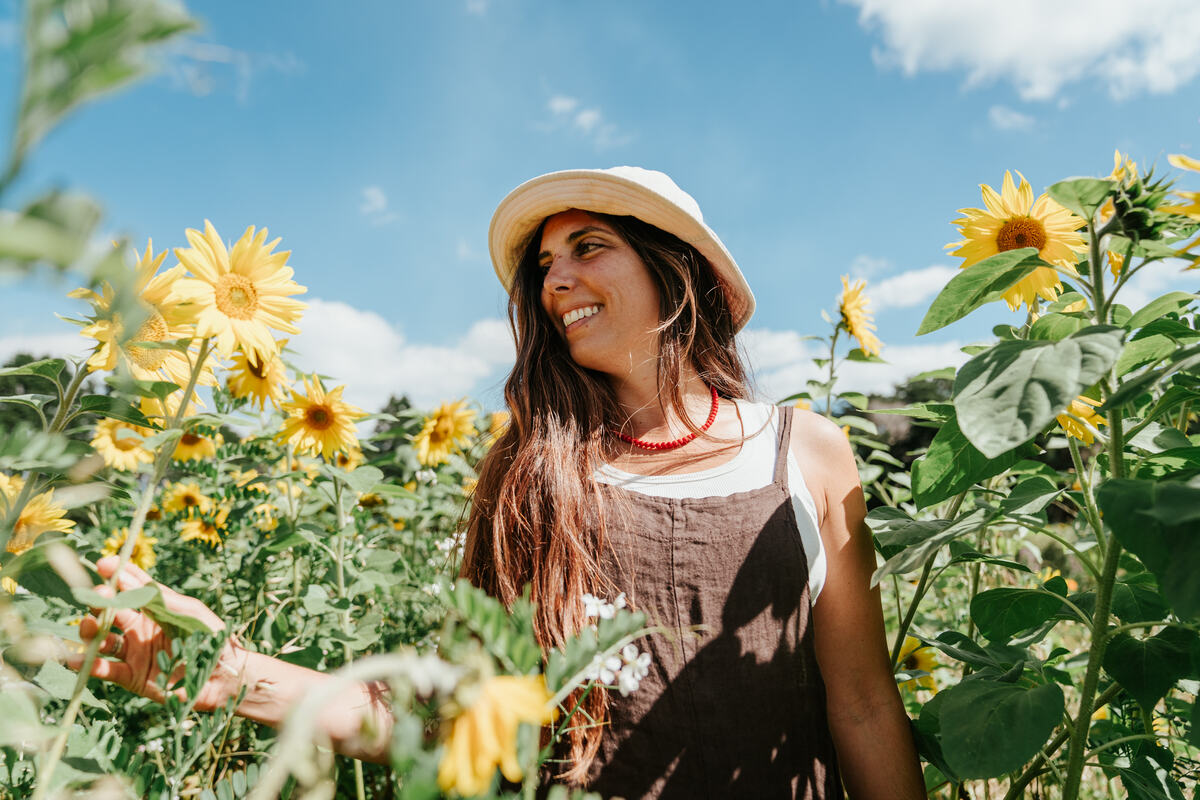 Smiling visitor in the sunflower maze at Mangaroa Farms