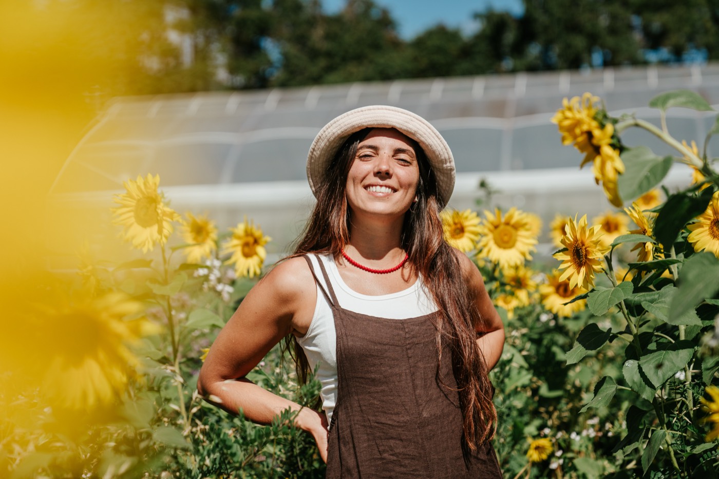 A smiling crew member among the sunflowers at Mangaroa Farms
