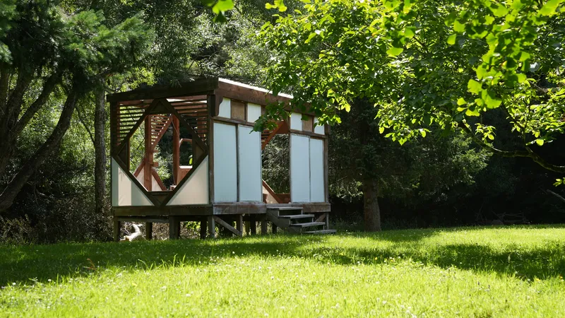 The writing hut glimpsed through the trees at Woodcote