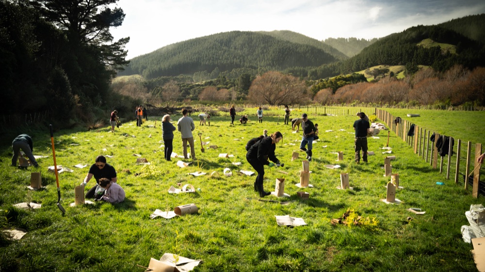 A farm worker laughing with muddy hands